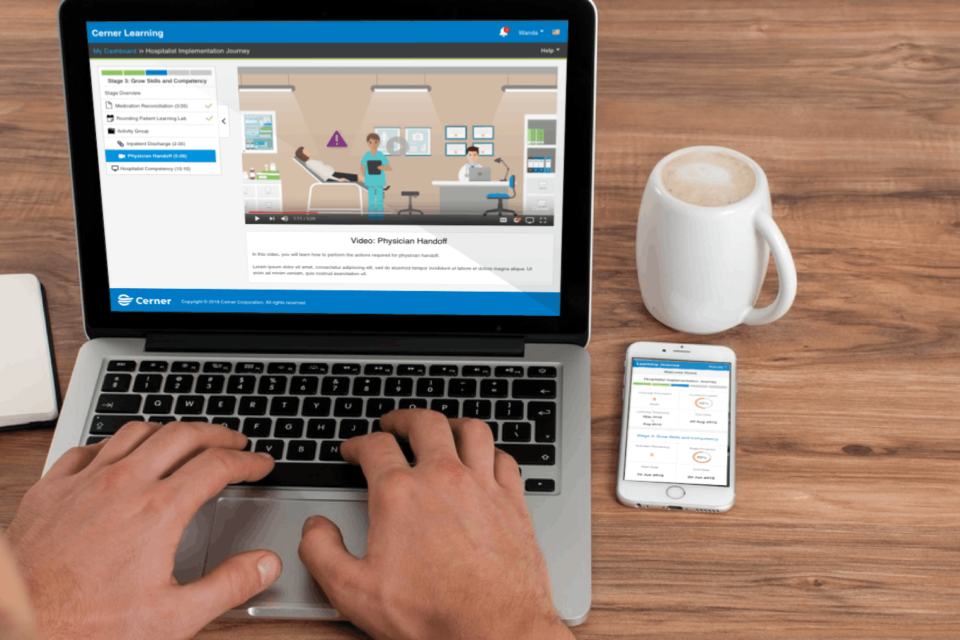 The Cerner Learning platform shown on a laptop and phone side by side on a desk, the learner experience in its real context.