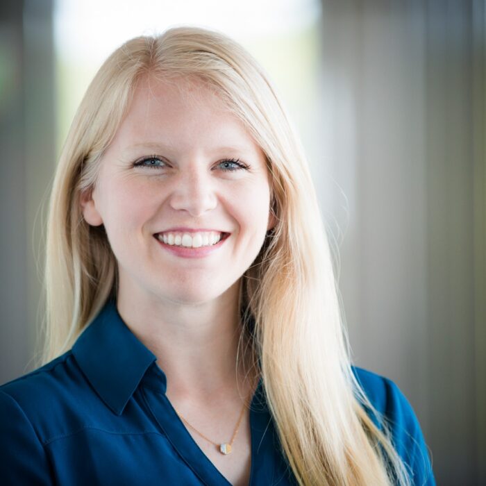 Personal brand portrait, on-location with soft blurred interior background.