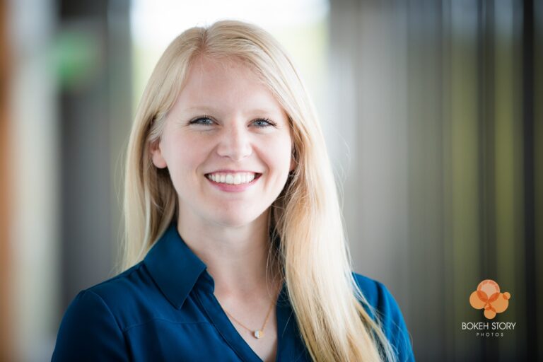 Personal brand portrait, on-location with soft blurred interior background.