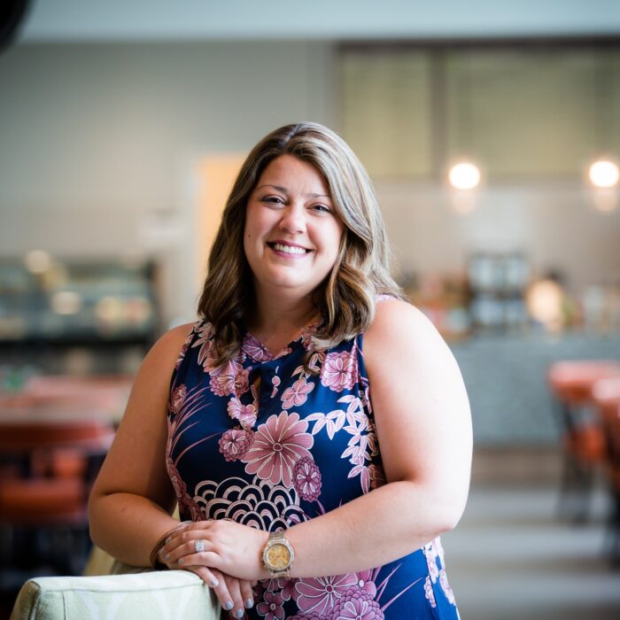 Corporate portrait of a Norterre team member, on-location in a café-style common area.