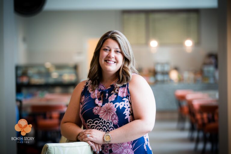 Corporate portrait of a Norterre team member, on-location in a café-style common area.