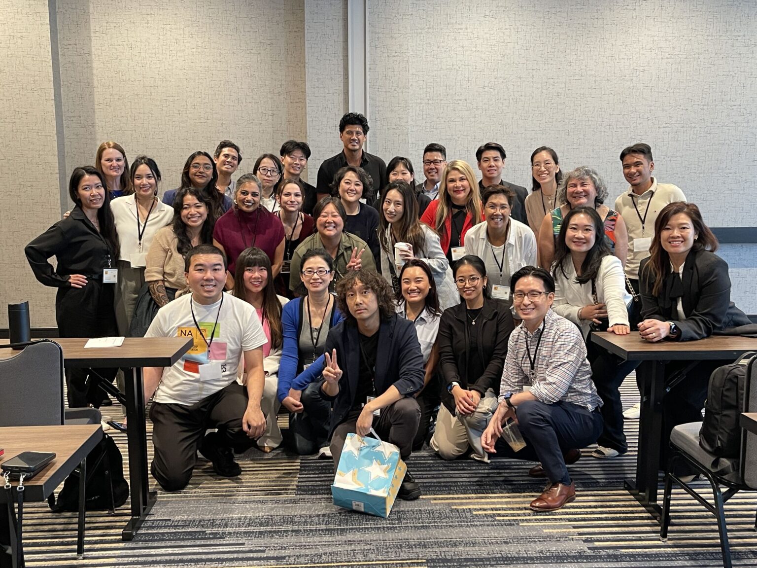 Candid group photo of roughly 25 NAAAP attendees posed together in a conference room, Leadership Convention, Kansas City, August 2025.