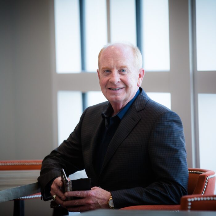 Executive portrait of Steve Shields, CEO of Norterre, seated at a table with large windows behind him.