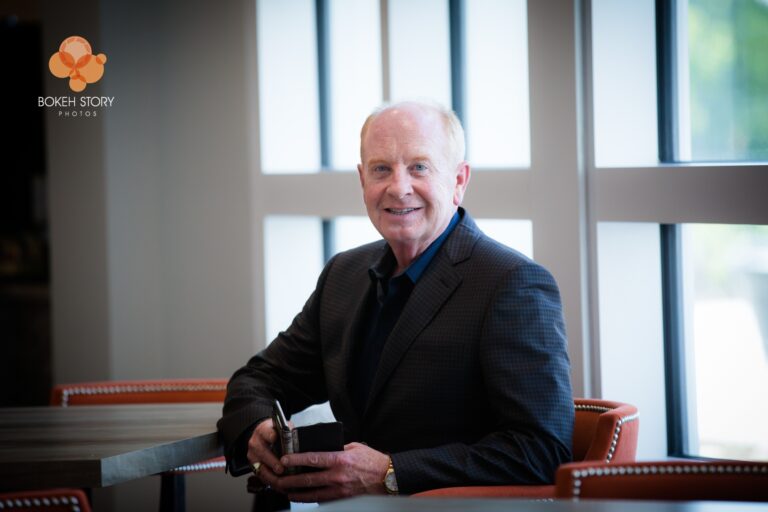 Executive portrait of Steve Shields, CEO of Norterre, seated at a table with large windows behind him.