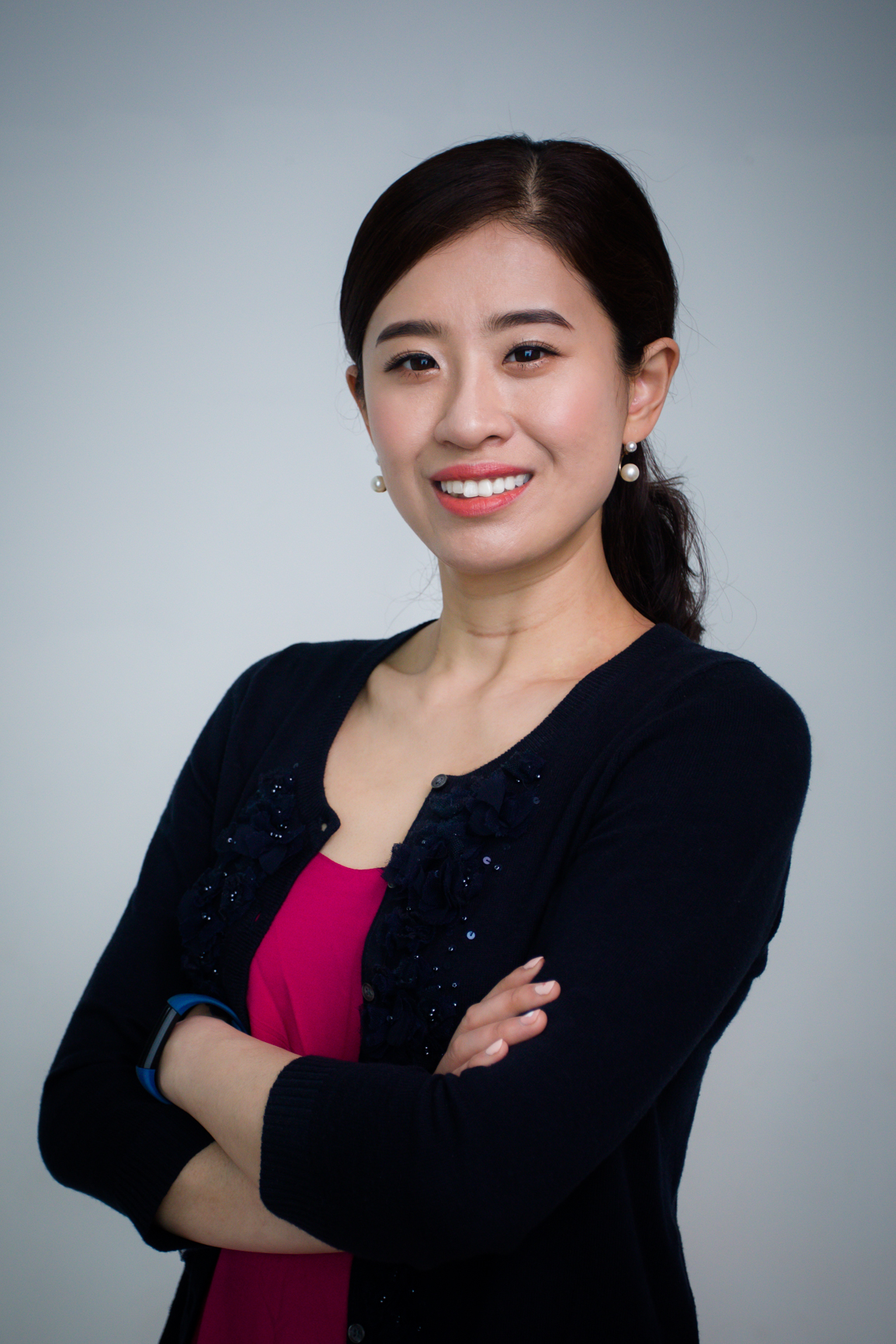 Studio portrait of Lai Xu with her arms crossed.